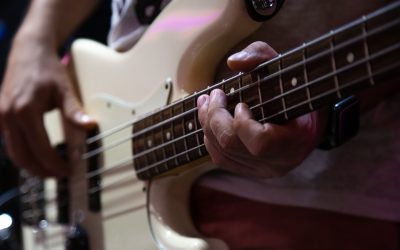 Part of bass guitar close up while playing.